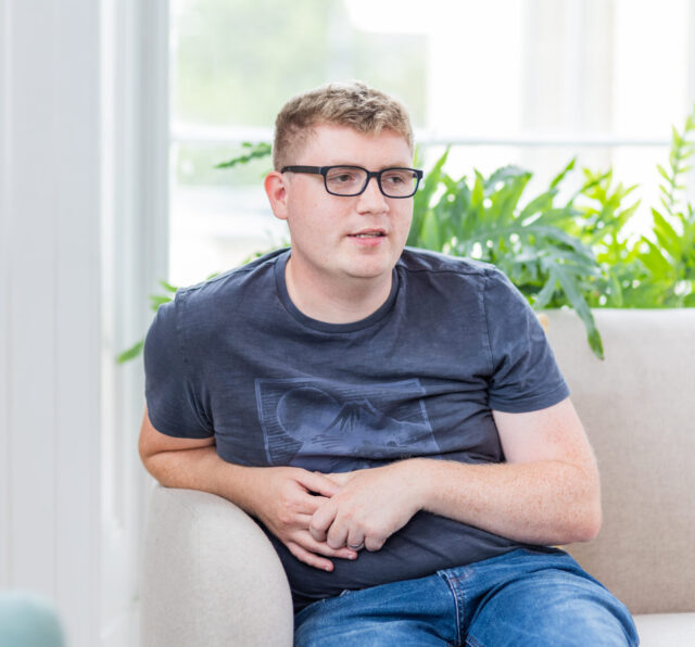 Photo of Dan Jacques, sitting on a sofa in the Barnwood Welcome area.