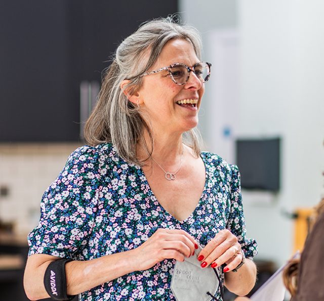 Photo of Nicola Mosley, chatting to a staff member.