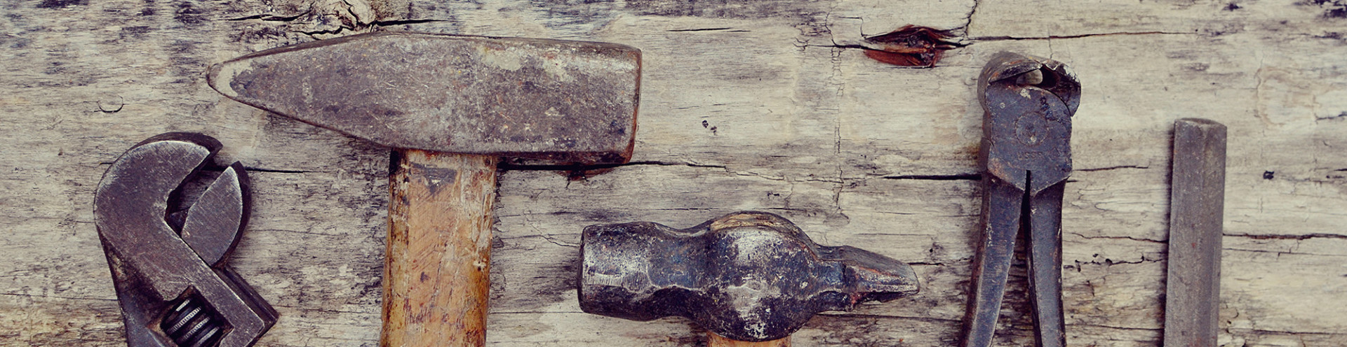 The carpenter's old tools on a wooden background