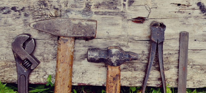 The carpenter's old tools on a wooden background