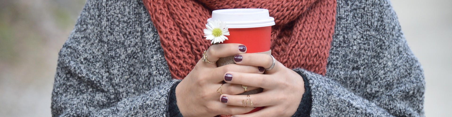 A community member holding a cup of coffee.