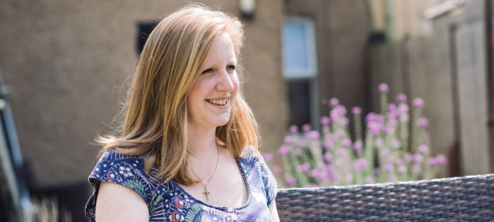 Team member Hannah sitting in a community space.