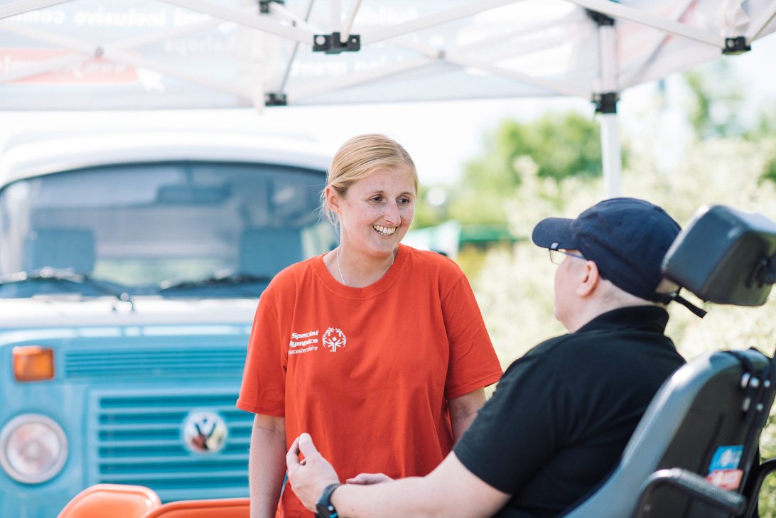 Team member informing a community member in a community event.