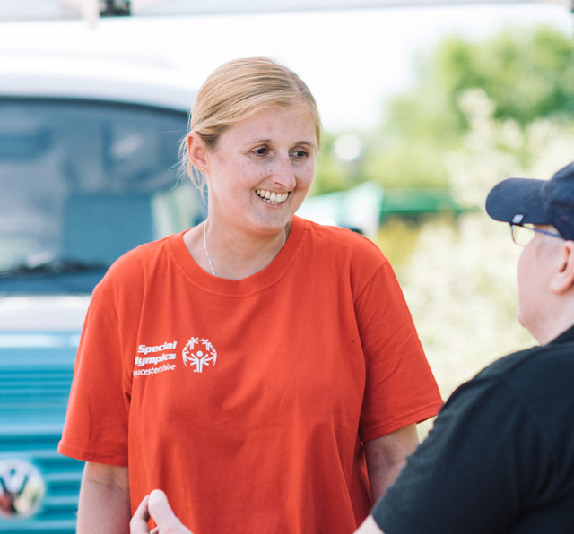 Team member informing a community member in a community event.