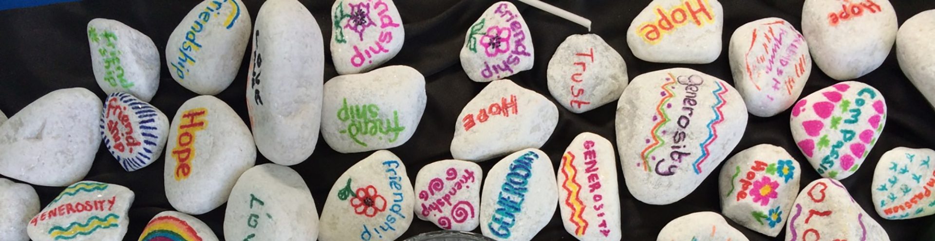 Beautiful stones with positive messages on a desk.