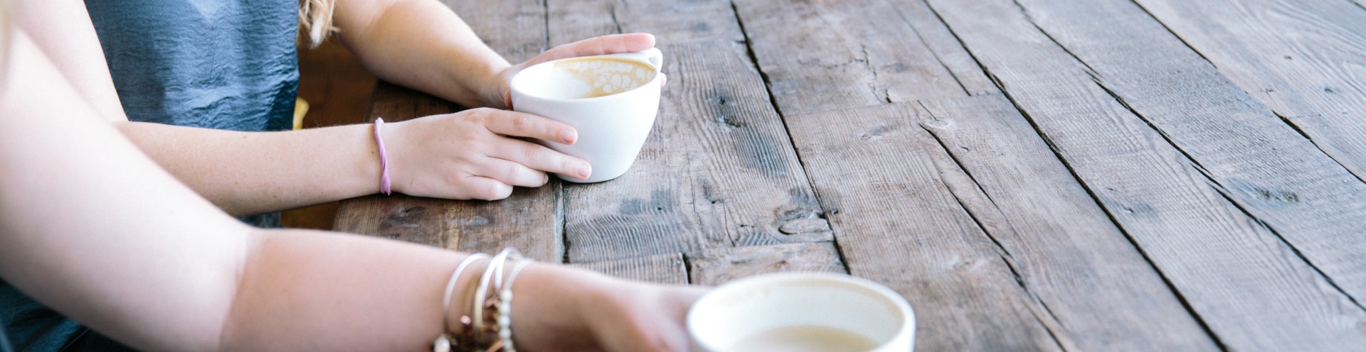 Community members holding coffee cups.