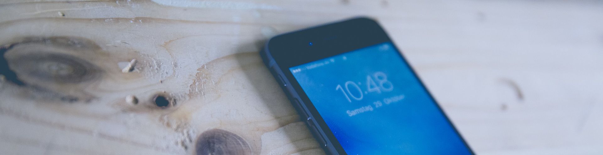 A cell phone on a desk.