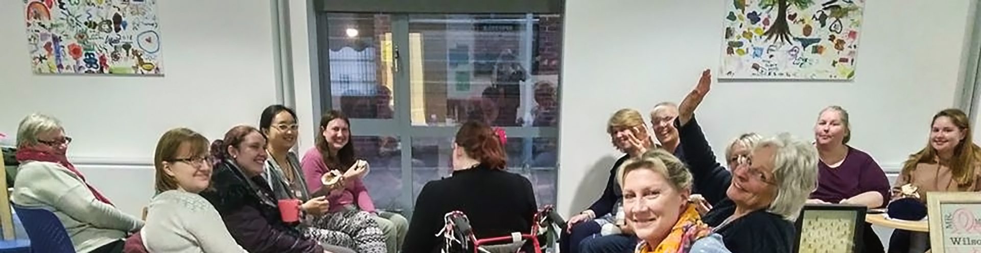 Art group members smiling in a workshop.