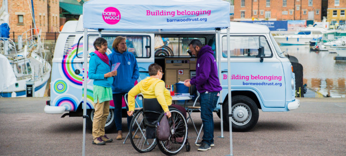 Barnwood Trust members informing a person with disability about their work.