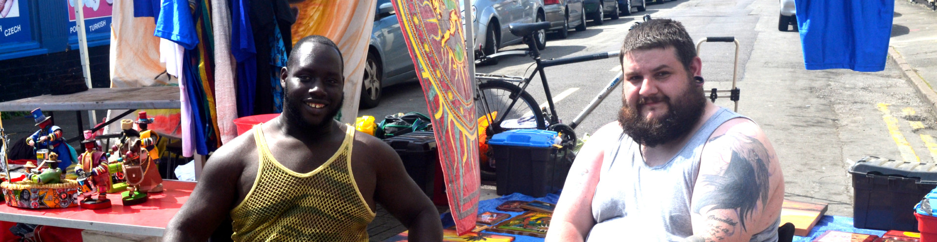 Community members smiling at the camera on the street.