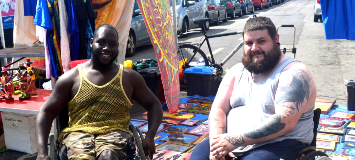 Community members smiling at the camera on the street.