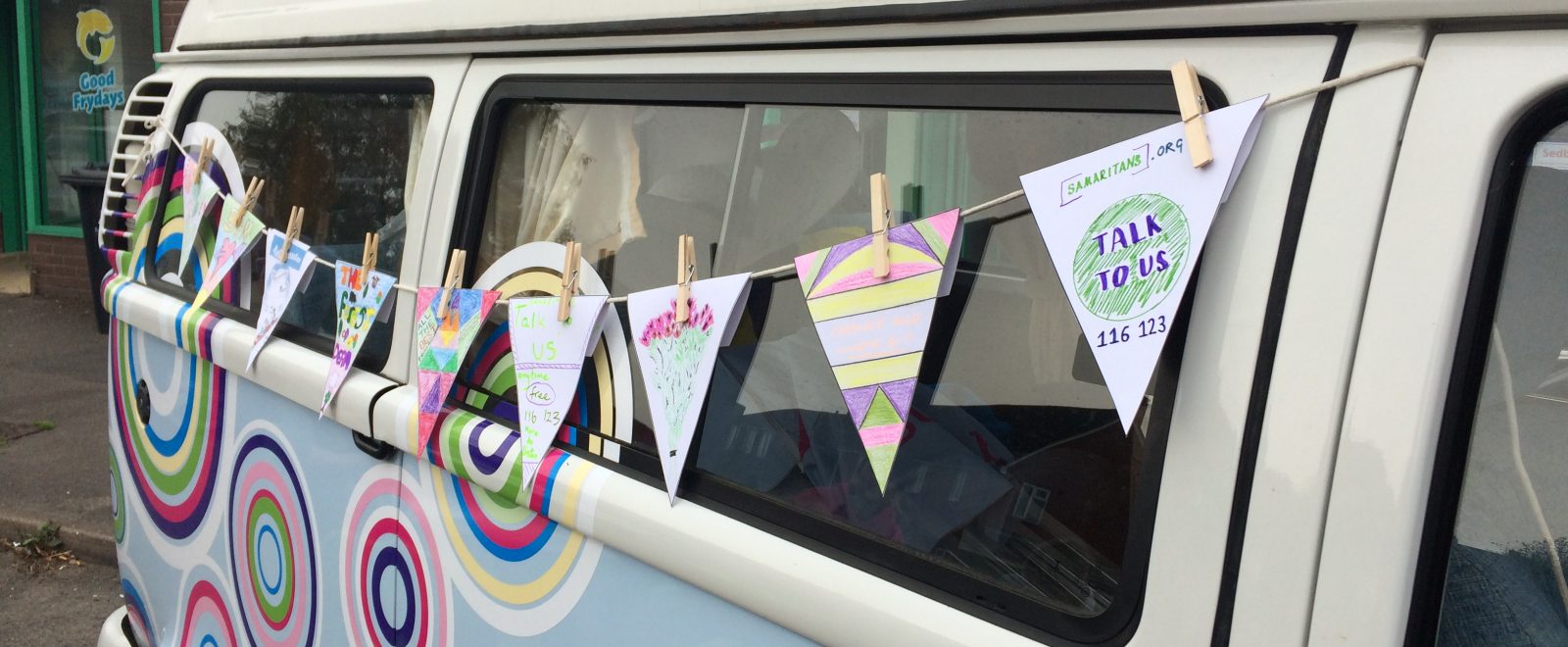 Beatiful tour camper van decorated with colourful flags.