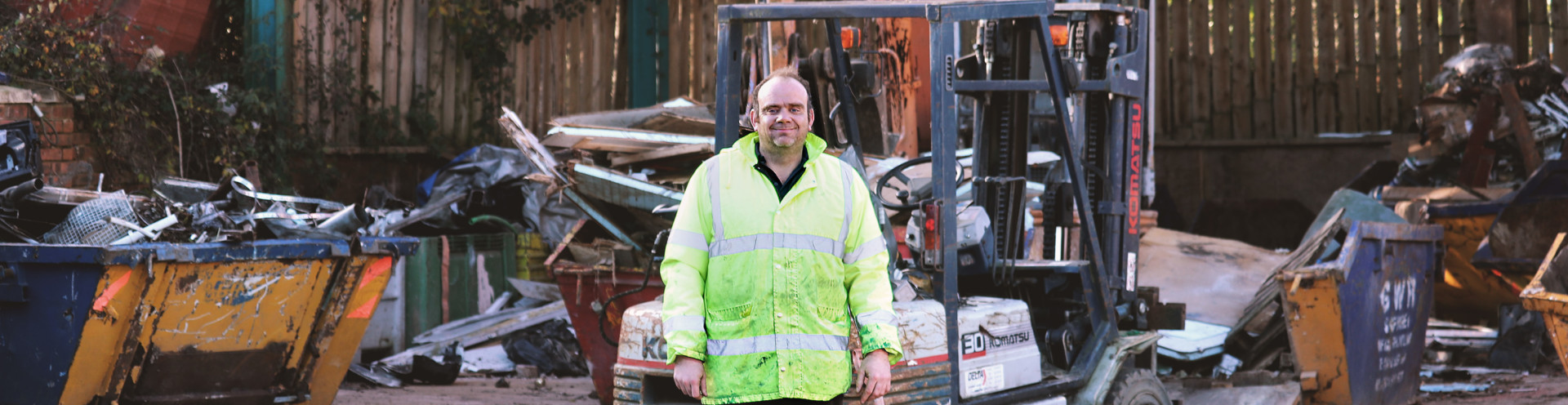 George next to a forklift in the Waste Management Centre