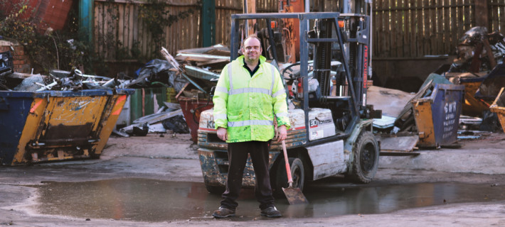 George next to a forklift in the Waste Management Centre