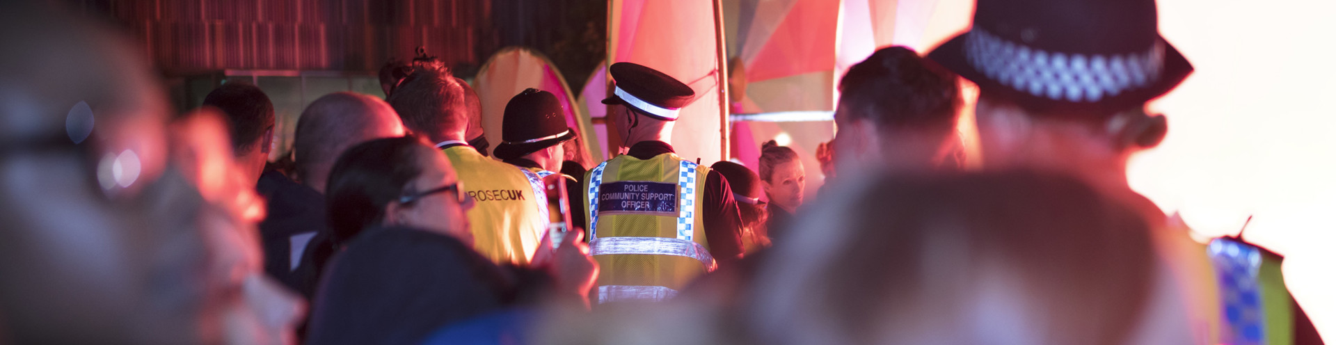Police monitor a crowd at a festival in the UK