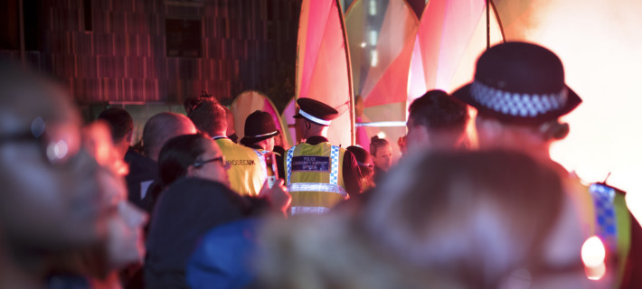 Police monitor a crowd at a festival in the UK