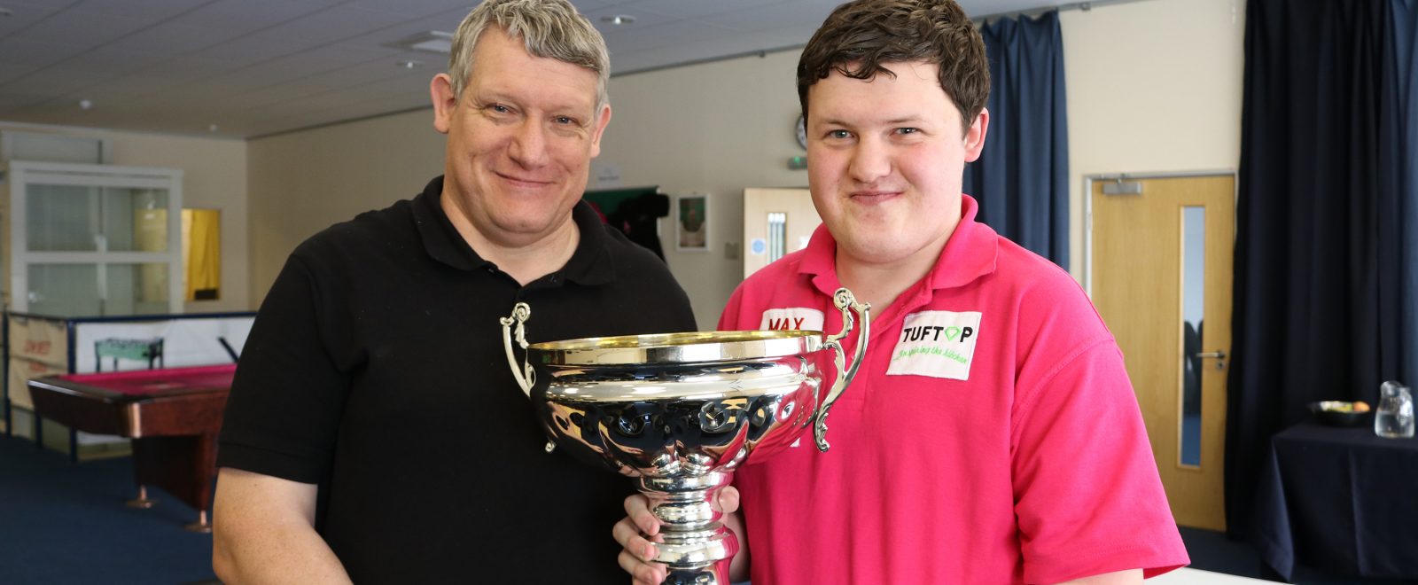 Aaron holding his trophy