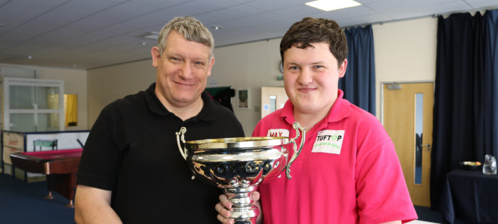 Aaron holding his trophy