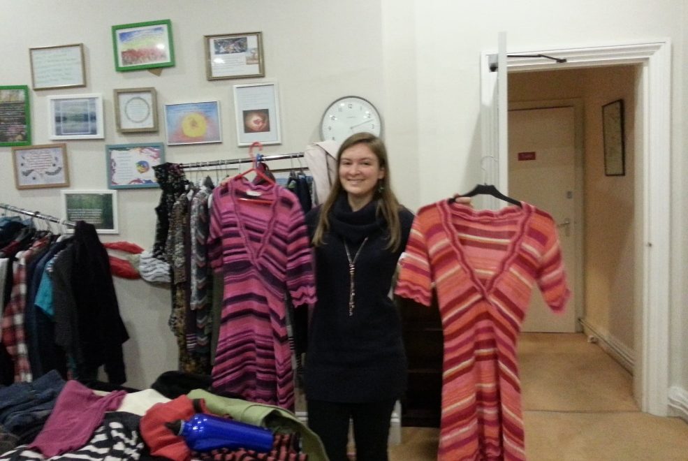 Woman holding lovely dresses on the swap evening