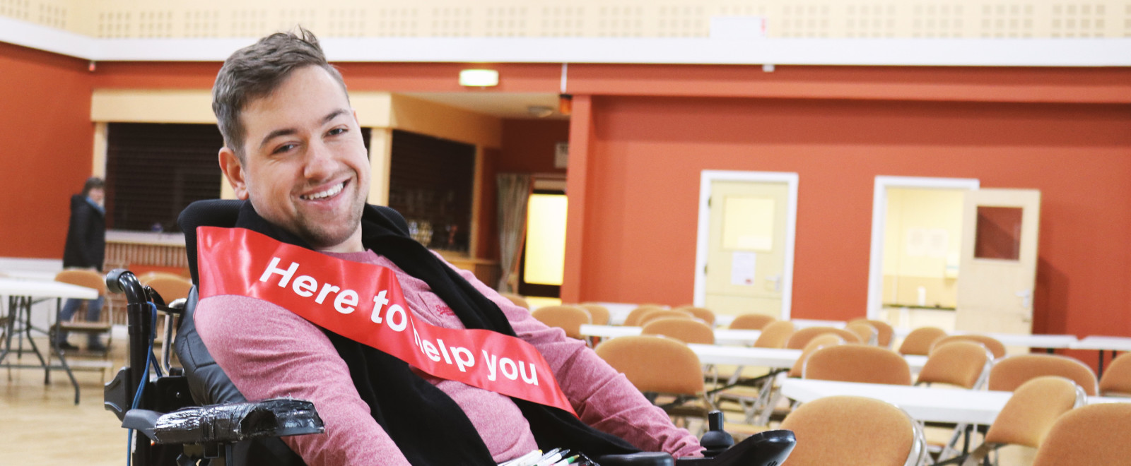 A person with disability smiling at the camera on the Know Your Right Days event
