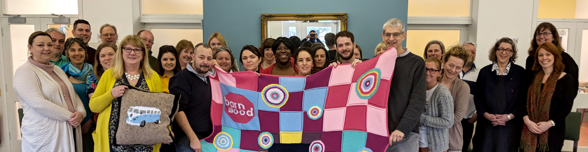 St Briavels Knitting group holding Barney's blanket.