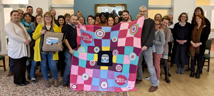 St Briavels Knitting group holding Barney's blanket.
