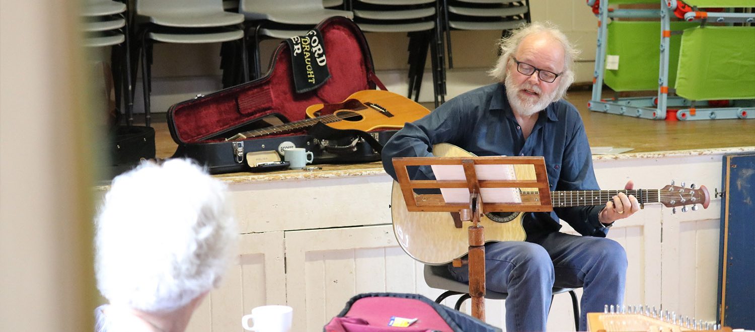A performer singing at the daylight acoustic club.