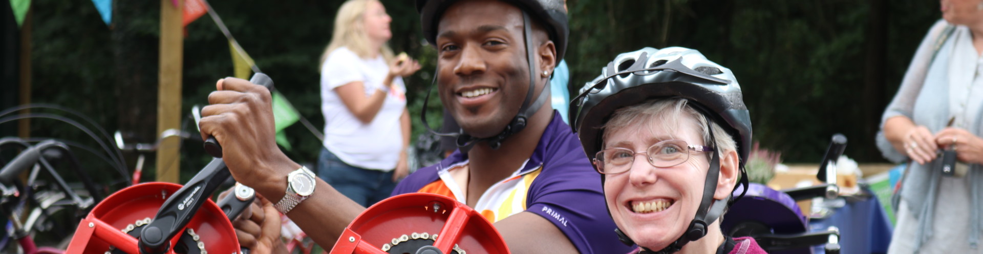 People smiling while they are using accessible bikes.