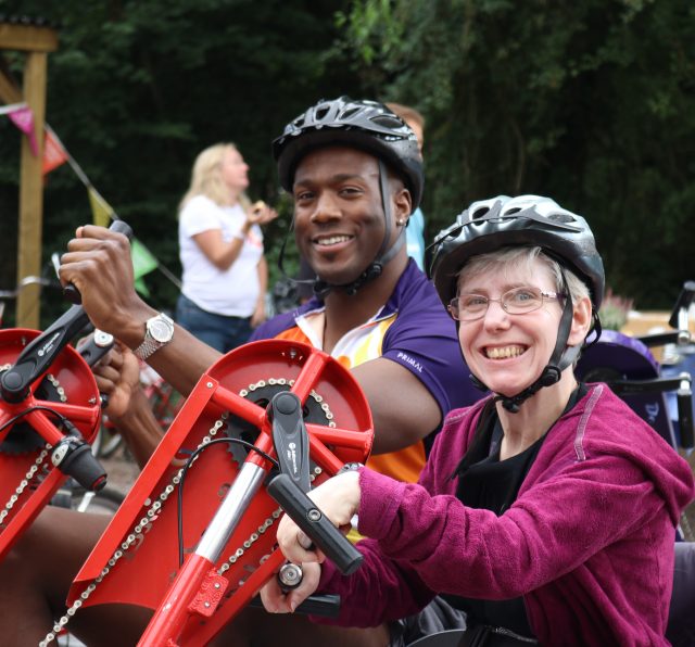 People smiling while they are using accessible bikes.