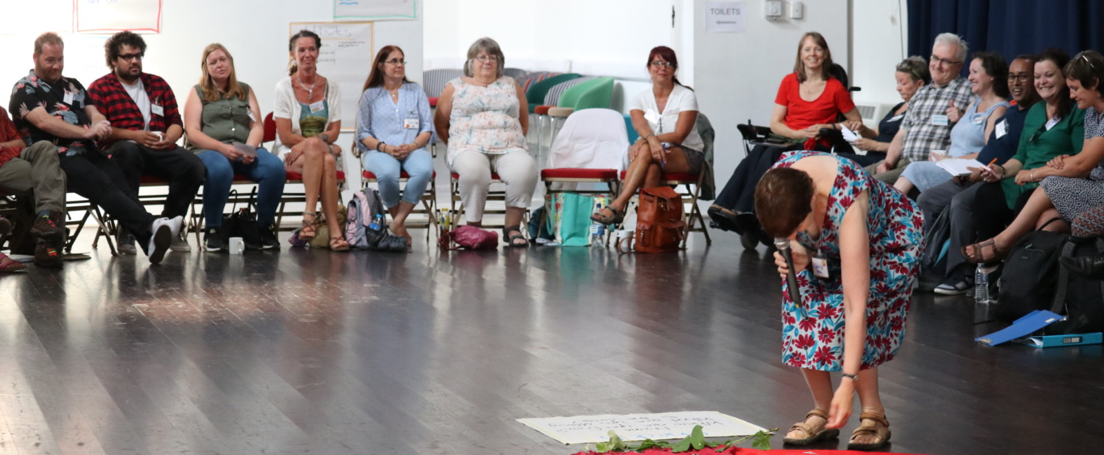 Attendees listening a speech at the participatory community building event