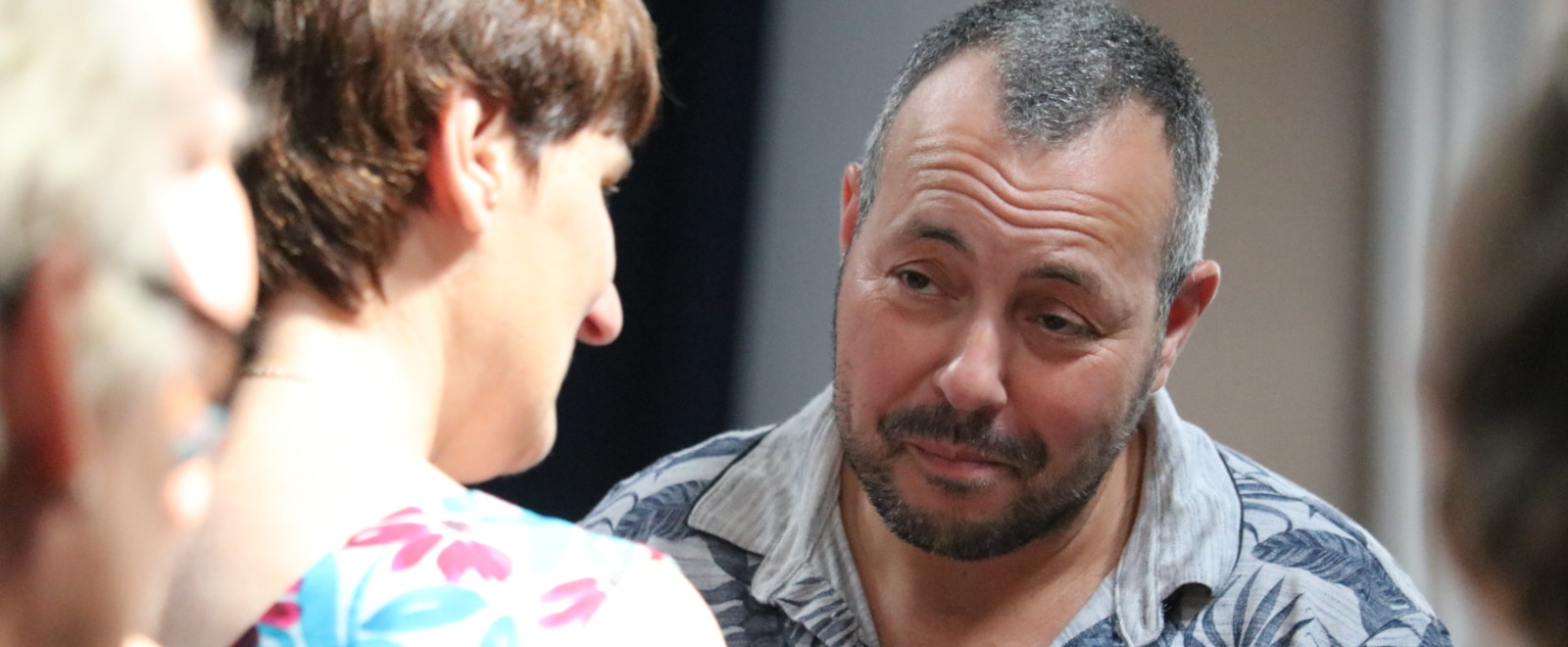 Man having a conversation with another attendee at the participatory community building event