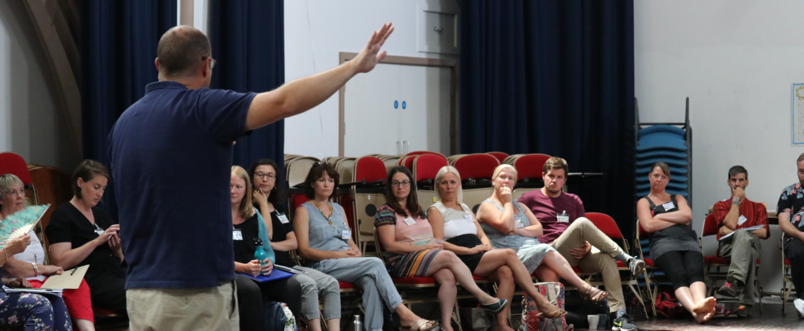 Man giving a speech in the participatory community building event