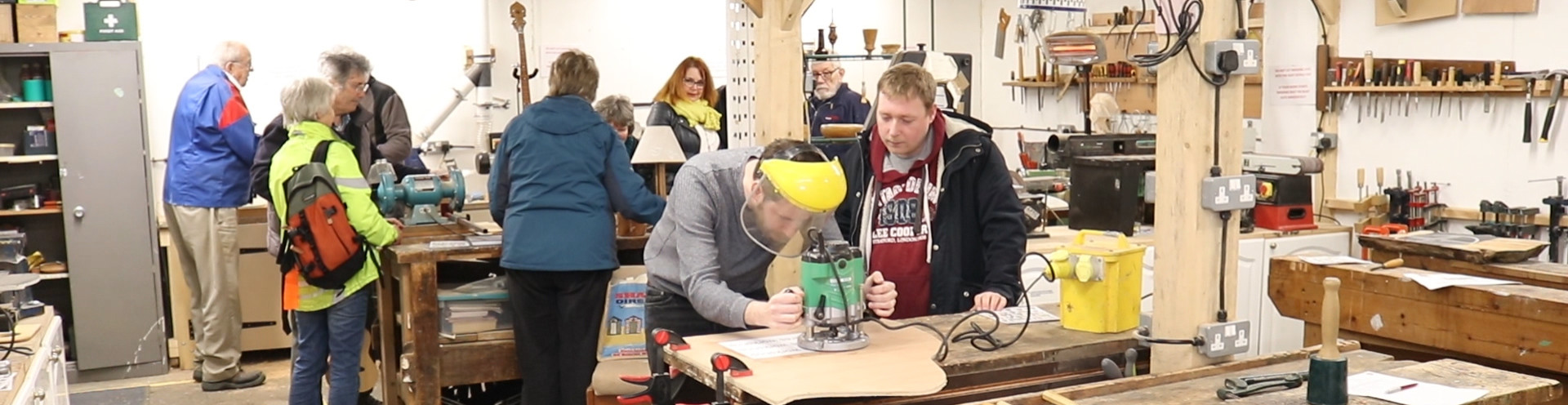 attendees working on woodwork in the community workshop