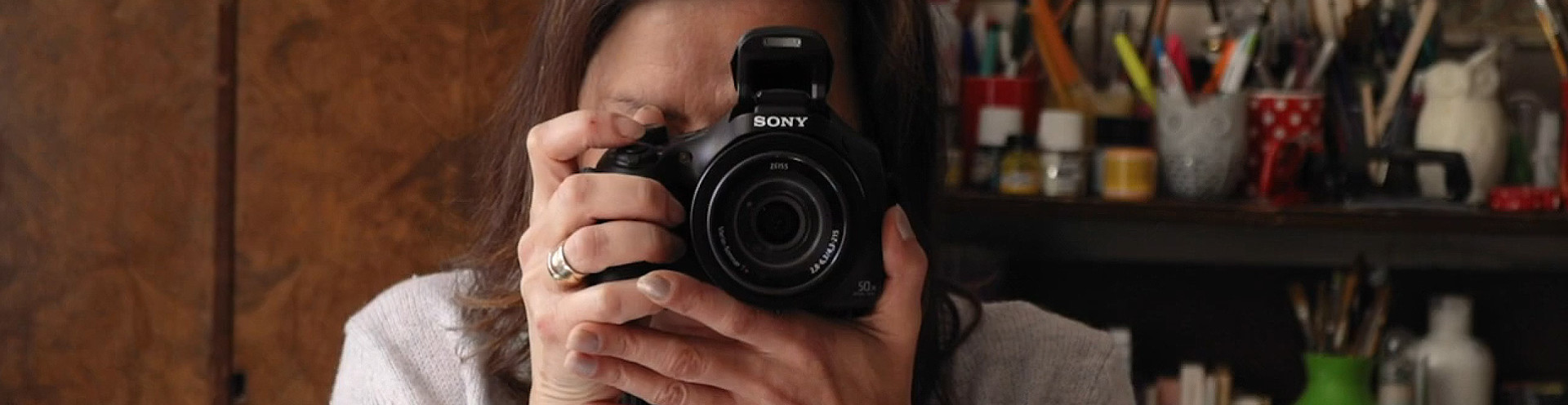 A grantee taking a picture with her new camera