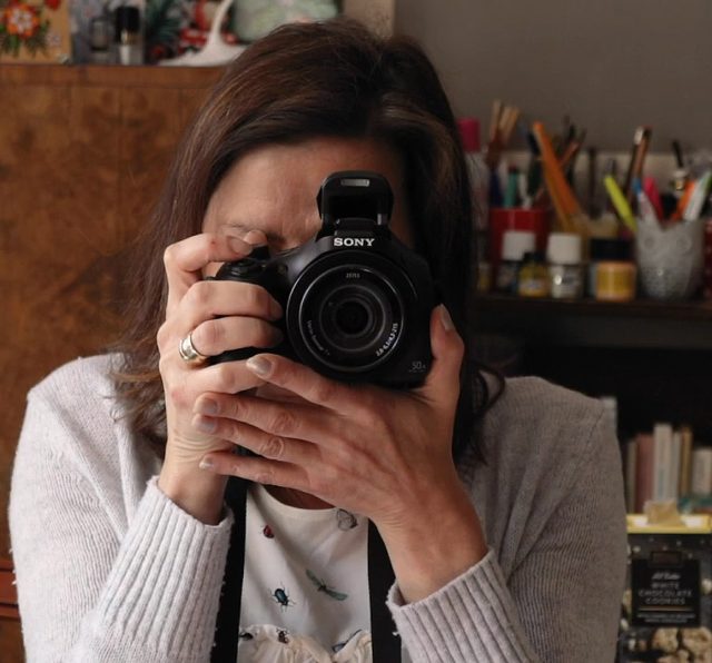 A grantee taking a picture with her new camera