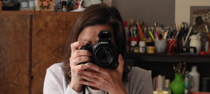 A grantee taking a picture with her new camera