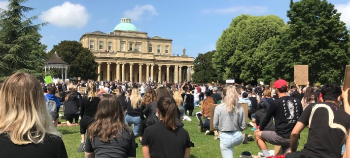 Photo of people kneeling at a BLM protest in Cheltenham.