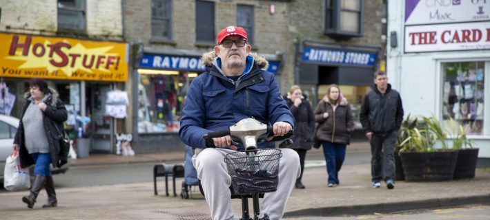Photo of a man in a mobility scooter