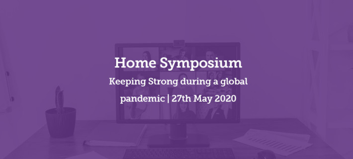 Photo of a computer on a table as a back setting to writing. Home Symposium, Keeping Strong during a global pandemic, 27th May 2020