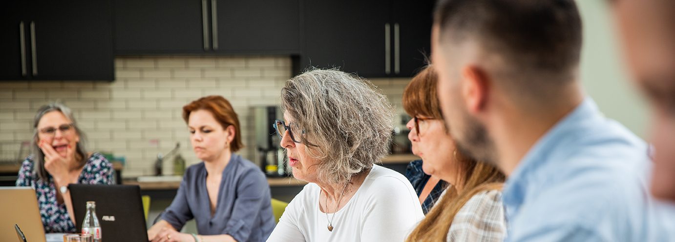 Photo of Sally Byng leading a meeting with Barnwood staff