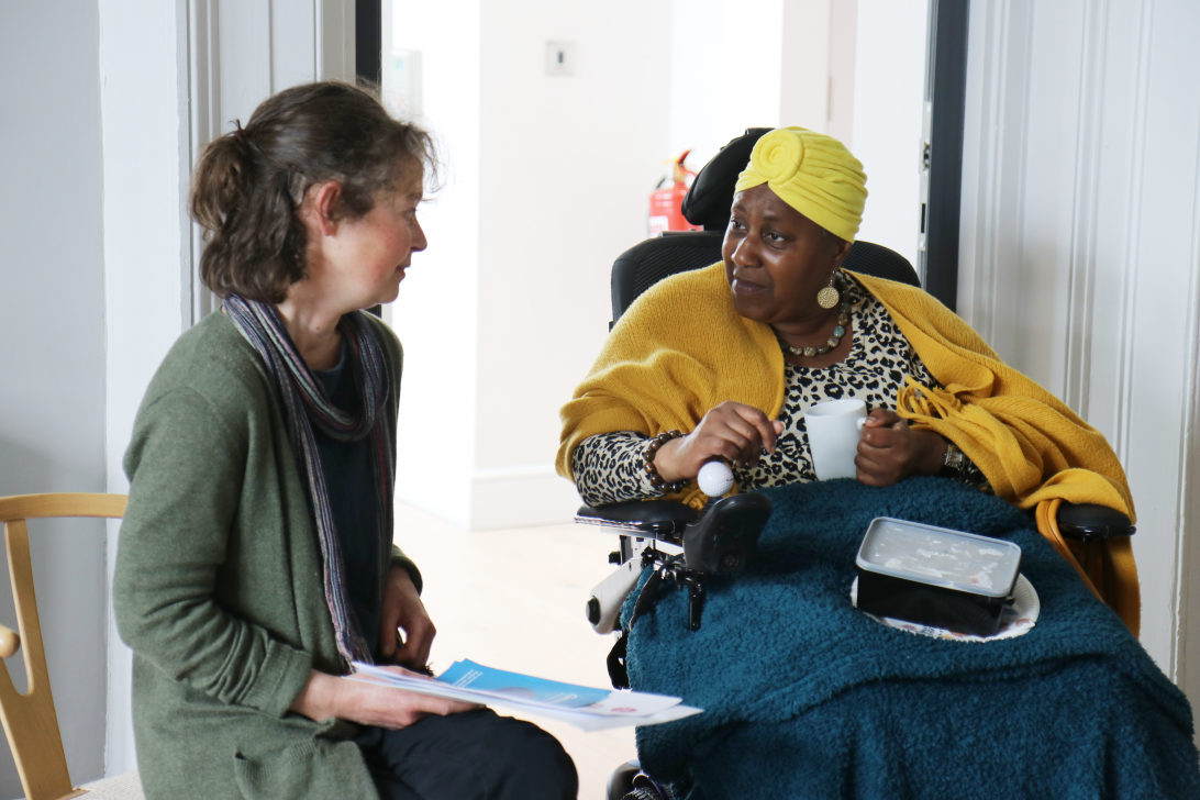 photo of a Barnwood Circle member talking to someone in the Barnwood staff team