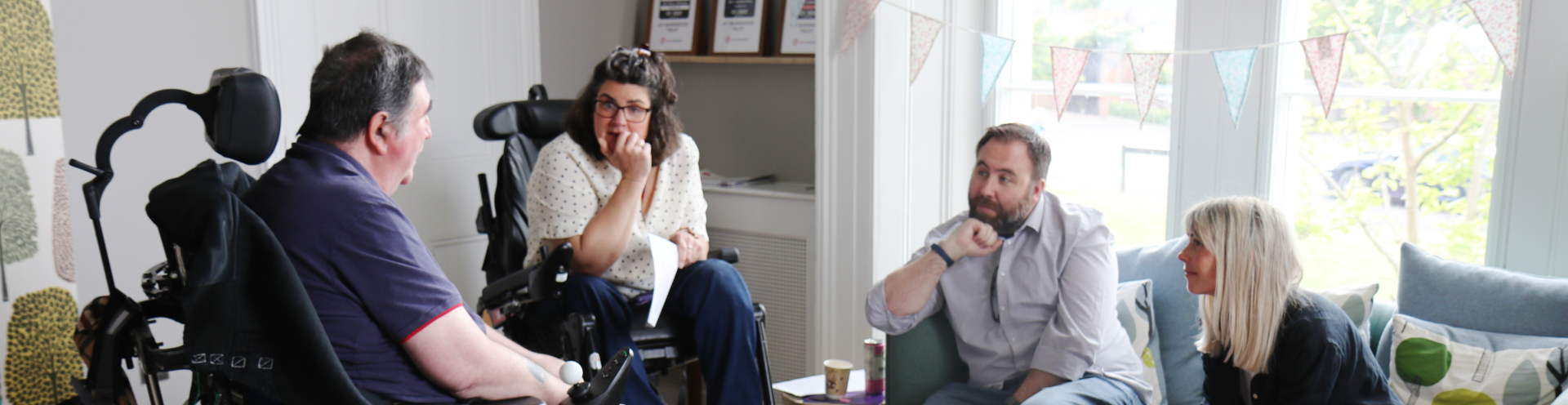 Photo of Barnwood staff and Barnwood Circle members chatting in Overton House