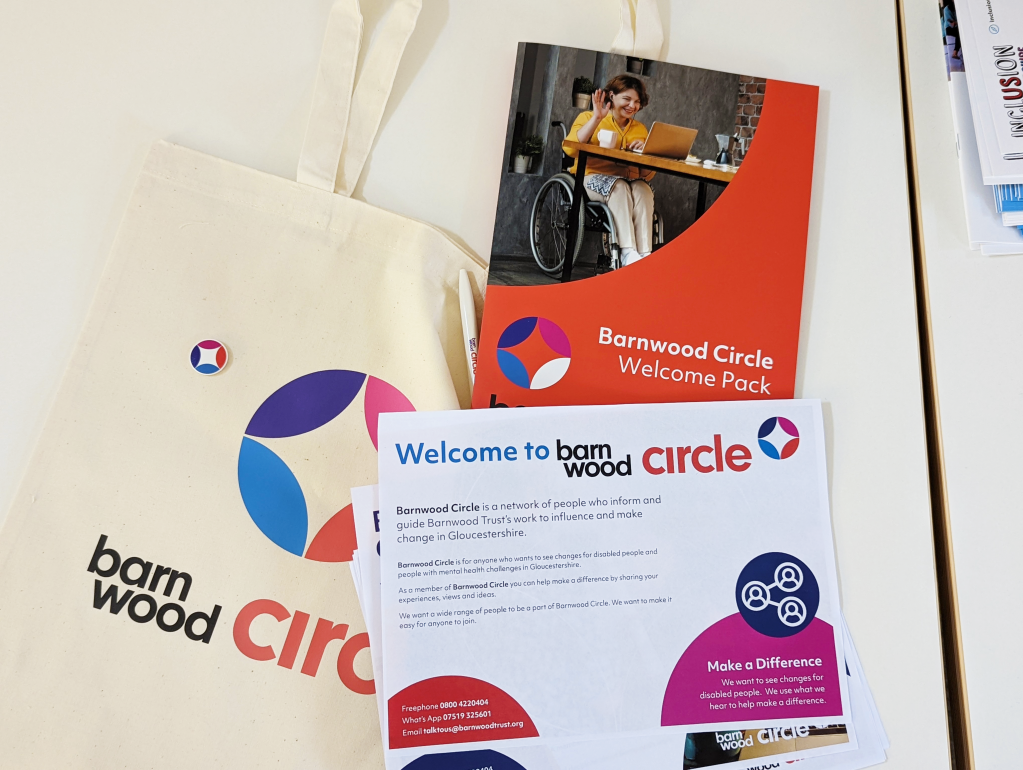 Photo of Barnwood Circle merchandise, a tote bag with the logo on, the welcome folder and a selection of inserts with details of the membership scheme