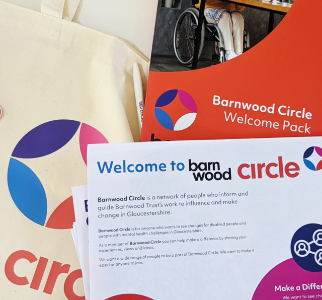 Photo of Barnwood Circle merchandise, a tote bag with the logo on, the welcome folder and a selection of inserts with details of the membership scheme