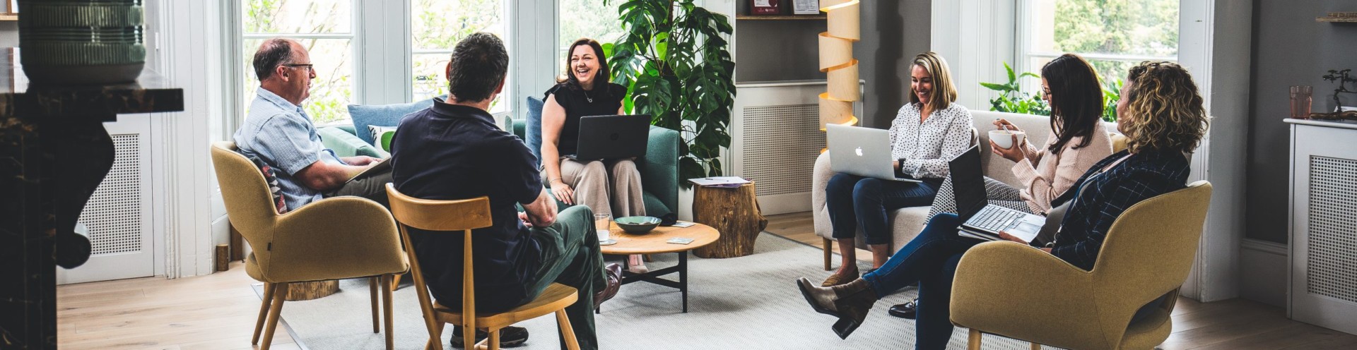 Barnwood Trsut employees sitting on Welcome Area sofas having informal meeting