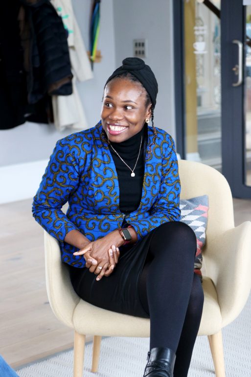 Photo of Wey Ofenor, sitting down in a chair and smiling