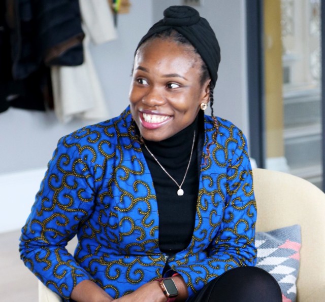 Photo of Wey Ofenor, sitting down in a chair and smiling