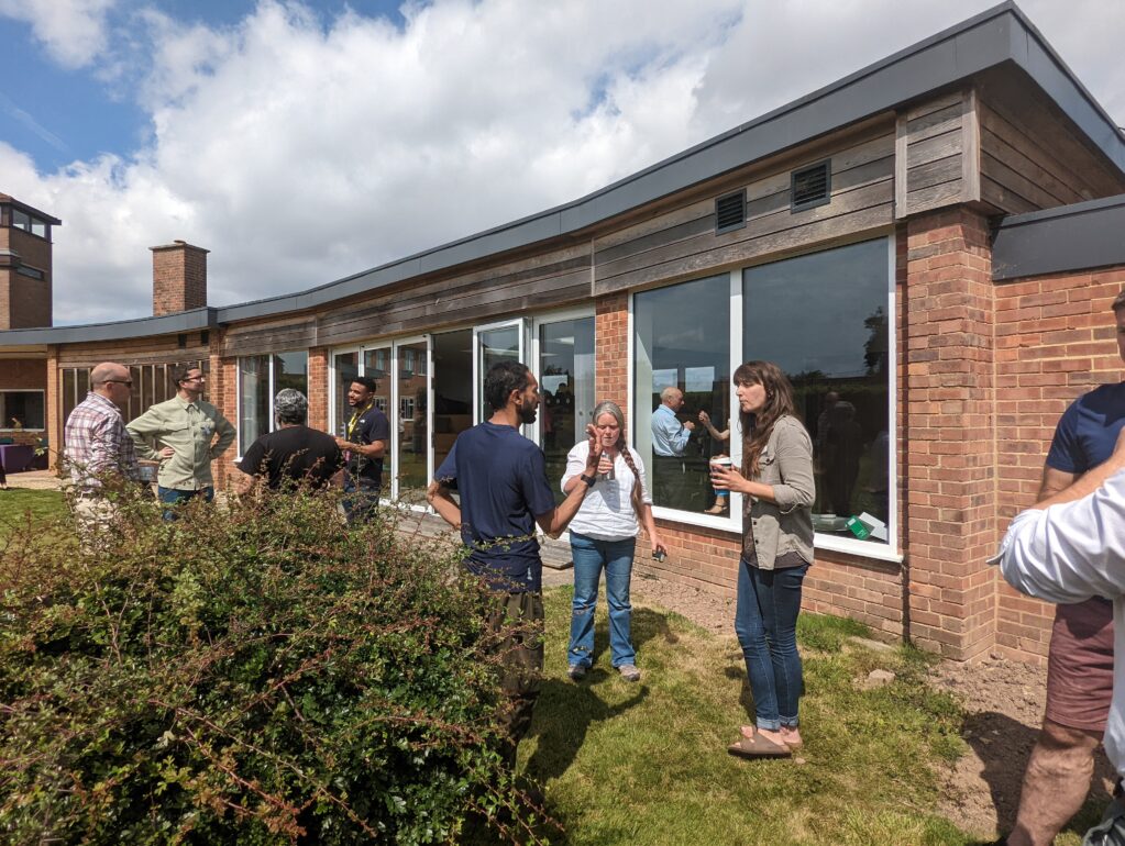 Photo of a people enjoying the garden outside the Garden Room at WWT Slimbridge Wetland Centre