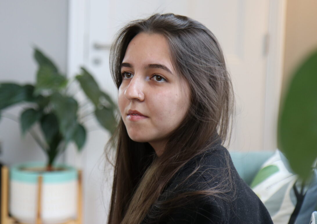 Photo of G Kadyrova, sitting on a sofa.