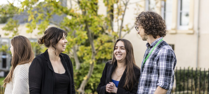 Three members of Barnwood Trust staff laughing outside